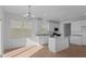 Bright kitchen featuring white cabinetry, stainless steel appliances, large island, and a pantry at 1837 James Pierce Dr, Shelbyville, IN 46176