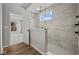 Tiled shower with glass partition and rainfall shower head, and an open doorway to a bedroom at 5006 Carmine St, Brownsburg, IN 46112