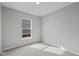 This empty carpeted bedroom features a window with a view of the outdoors at 5006 Carmine St, Brownsburg, IN 46112