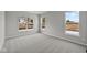 A spacious bedroom features three bright windows and neutral colored carpet at 5006 Carmine St, Brownsburg, IN 46112