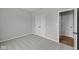 Carpeted bedroom features a closet and an open doorway to another room with wood flooring at 5006 Carmine St, Brownsburg, IN 46112