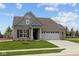 Attractive single-story home with a brick front, attached garage, and green lawn in a suburban setting at 5006 Carmine St, Brownsburg, IN 46112