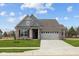 Charming single-story home featuring a brick facade, two-car garage, and well-manicured lawn at 5006 Carmine St, Brownsburg, IN 46112