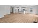 Bright, open-concept living space with hardwood flooring, connecting the kitchen and living area for seamless entertaining at 5006 Carmine St, Brownsburg, IN 46112
