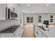 Contemporary kitchen with stainless appliances, island sink, and seamless flow into the dining and living areas at 5006 Carmine St, Brownsburg, IN 46112