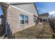 Backyard with brick exterior and patio including a black wrought iron fence and green foliage at 5677 Starla Ln, Plainfield, IN 46168