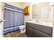Bathroom featuring a vanity with dark wood cabinets and a blue and gray striped shower curtain at 5677 Starla Ln, Plainfield, IN 46168