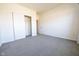 Vacant bedroom with gray carpet, closet with sliding doors and a door leading to another room at 5677 Starla Ln, Plainfield, IN 46168
