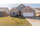 Inviting single-story home showcases a well-maintained front yard, brick facade, and attached two-car garage at 5677 Starla Ln, Plainfield, IN 46168