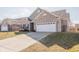 Well maintained home with an attached two-car garage and a large driveway at 5677 Starla Ln, Plainfield, IN 46168