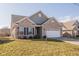 Charming, single-story home features a brick facade, attached two-car garage, and manicured front lawn at 5677 Starla Ln, Plainfield, IN 46168