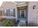 A welcoming front porch with a decorative front door and black shutters at 5677 Starla Ln, Plainfield, IN 46168