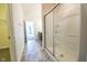 Hallway bathroom with walk-in glass shower and vanity with white countertop at 5677 Starla Ln, Plainfield, IN 46168