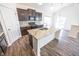 Spacious kitchen featuring stainless steel appliances, granite countertops, island and dark wood cabinets at 5677 Starla Ln, Plainfield, IN 46168