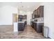 The kitchen has stainless steel appliances, dark cabinets, and an island with marble countertops at 5677 Starla Ln, Plainfield, IN 46168