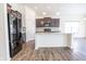 Open-concept kitchen with a center island, stainless steel appliances, and dark wood cabinets at 5677 Starla Ln, Plainfield, IN 46168