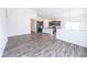 Open-concept living room showcasing the kitchen with wood cabinets and modern pendant lighting at 5677 Starla Ln, Plainfield, IN 46168