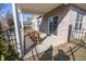 Covered patio with brick columns and a set of wooden furniture with a black wrought iron fence at 5677 Starla Ln, Plainfield, IN 46168