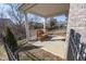 Covered patio featuring a wood bench with a black wrought iron fence and backyard view at 5677 Starla Ln, Plainfield, IN 46168