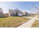 A street view of a well-maintained neighborhood with sidewalks, and landscaped yards at 5677 Starla Ln, Plainfield, IN 46168