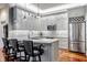 Modern kitchen with gray cabinets, quartz countertops, and stainless steel appliances at 659 Ellsworth St, Indianapolis, IN 46202