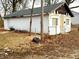Side exterior view of small home with white paint and some landscaping at 1214 N Penn St, Muncie, IN 47303