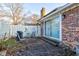 Enclosed brick patio with sliding doors, grill, and white fence; needs landscaping at 2856 Jamieson Ln, Indianapolis, IN 46268