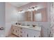 Bright bathroom featuring a double sink vanity and a large mirror with decorative lighting at 2856 Jamieson Ln, Indianapolis, IN 46268