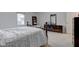 Dark bedroom with neutral walls showcasing a dresser, mirror and bed featuring a patterned duvet at 2856 Jamieson Ln, Indianapolis, IN 46268