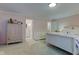 Light and airy bedroom with elegant white furnishings and a view into an adjoining bathroom at 2856 Jamieson Ln, Indianapolis, IN 46268