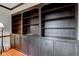 Detailed view of the living room's built-in shelving, cabinets, and hardwood floors at 2856 Jamieson Ln, Indianapolis, IN 46268
