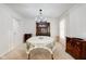 Dining room area featuring chandelier, curtains, china cabinet, and neutral colors at 2856 Jamieson Ln, Indianapolis, IN 46268