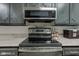 Stainless steel oven and microwave in a cozy kitchen with granite countertops at 2856 Jamieson Ln, Indianapolis, IN 46268