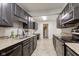 A well-organized kitchen with stone countertops, tile floors, and sleek appliances at 2856 Jamieson Ln, Indianapolis, IN 46268