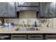 Close-up of a kitchen sink with granite countertop and tile backsplash at 2856 Jamieson Ln, Indianapolis, IN 46268