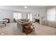 Spacious living room with a fireplace, large windows, and neutral-toned carpet at 2856 Jamieson Ln, Indianapolis, IN 46268
