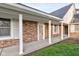 Inviting front porch showcasing brickwork, white columns, and windows with shutters at 2856 Jamieson Ln, Indianapolis, IN 46268