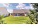 Well maintained backyard with healthy, green grass and trees on a partly sunny day at 3538 Heathcliff Ct, Westfield, IN 46074