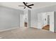 Bright bedroom with ceiling fan, plush carpeting, and ample closet space at 3538 Heathcliff Ct, Westfield, IN 46074