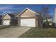 Two-car garage with brick and tan exterior at 3538 Heathcliff Ct, Westfield, IN 46074