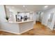 Open kitchen features stainless steel appliances, white cabinets, and breakfast bar at 3538 Heathcliff Ct, Westfield, IN 46074
