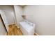 A compact laundry room features a white washer and dryer and a wire rack shelf at 3538 Heathcliff Ct, Westfield, IN 46074