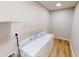 Convenient laundry room equipped with modern, white washing machine and dryer at 3538 Heathcliff Ct, Westfield, IN 46074