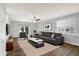 Living room with dark grey sectional sofa, wood floors, and patio access at 3538 Heathcliff Ct, Westfield, IN 46074