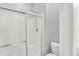 A shower with glass doors and white tiled walls at 3538 Heathcliff Ct, Westfield, IN 46074