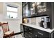 Butlers pantry with dark cabinetry, beverage fridge, coffee bar, and white subway tile at 4621 N Meridian St, Indianapolis, IN 46208