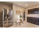 Kitchen features stainless steel refrigerator and breakfast nook at 5009 E Michigan E St, Indianapolis, IN 46201