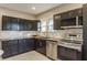 Modern kitchen with dark cabinets, stainless steel appliances at 5009 E Michigan E St, Indianapolis, IN 46201