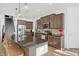 Kitchen with dark wood cabinets, granite countertops, and stainless steel appliances adjacent to the stairs at 6431 W Clearview Dr, McCordsville, IN 46055