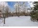 This home features a sprawling yard, mature trees, and lovely landscaping at 7027 Creekside Ln, Indianapolis, IN 46220